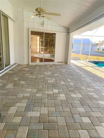 a view of a room with wooden floor and windows