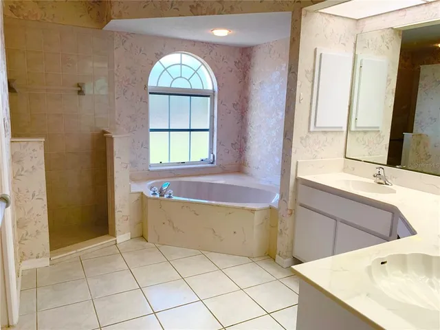 a bathroom with a bathtub and a window