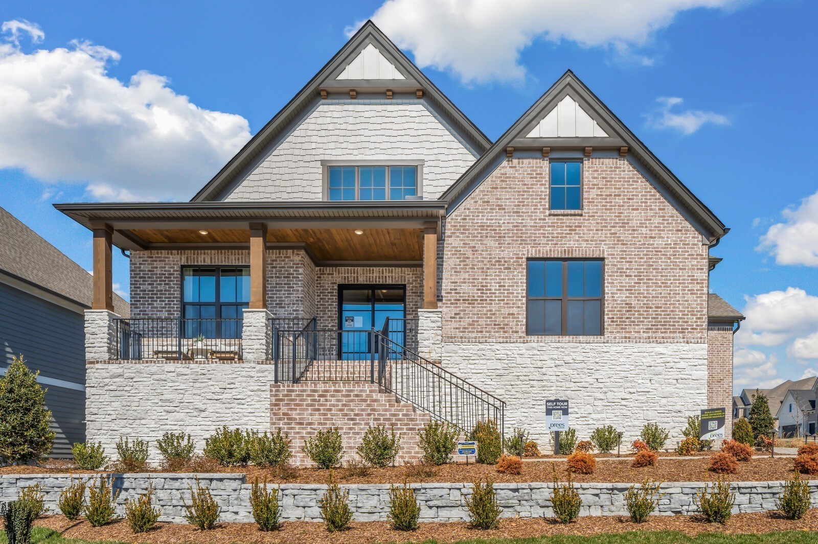 a view of a brick house with large windows