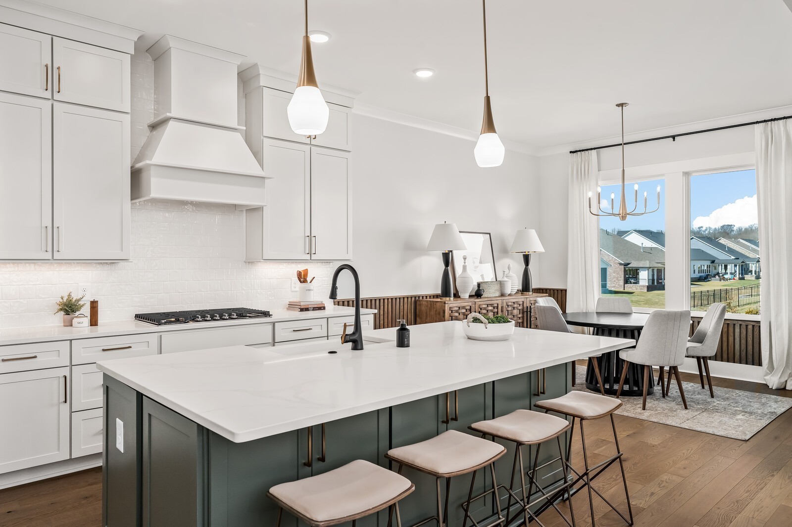 7280 Ruzek Court Fairview, TN 37062 - Photo 27 of 90 a kitchen with a dining table a sink cabinets and stainless steel appliances