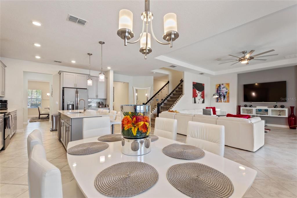 8811 Bally Neal Loop Davenport, FL 33896 - Photo 16 of 82 a living room with furniture kitchen view and a flat screen tv