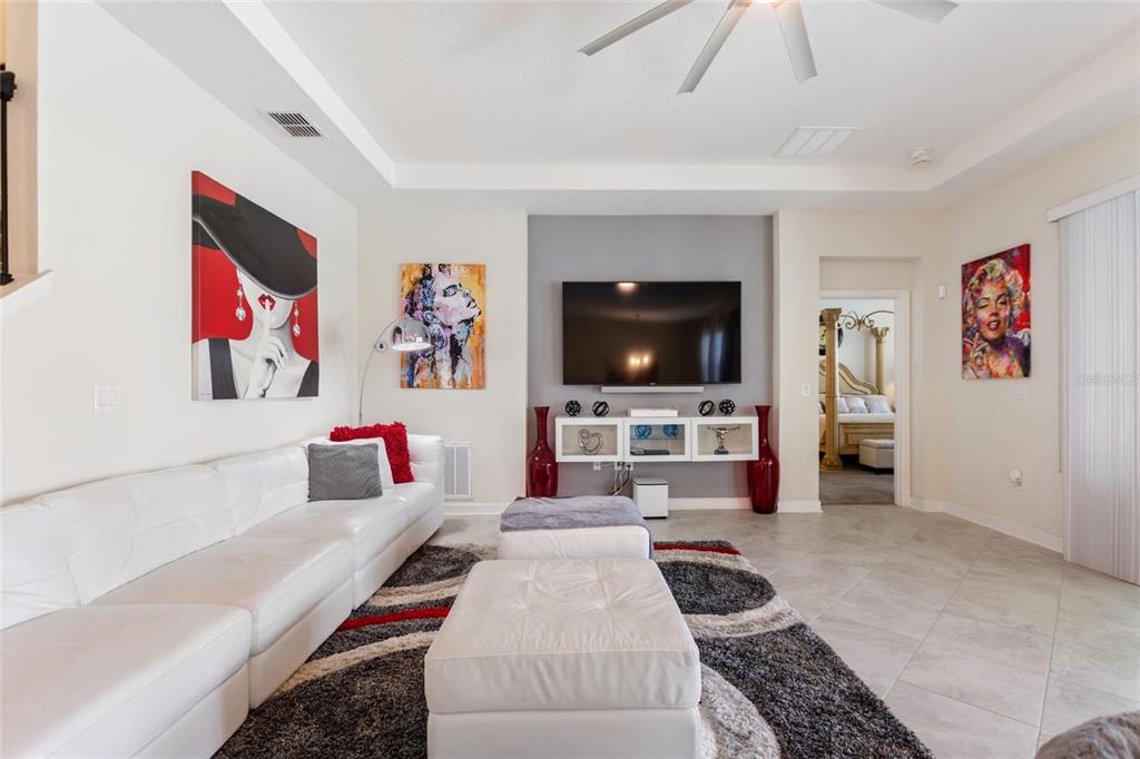 8811 Bally Neal Loop Davenport, FL 33896 - Photo 17 of 82 a living room with furniture and a flat screen tv