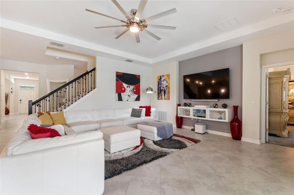8811 Bally Neal Loop Davenport, FL 33896 - Photo 18 of 82 a living room with furniture and a flat screen tv