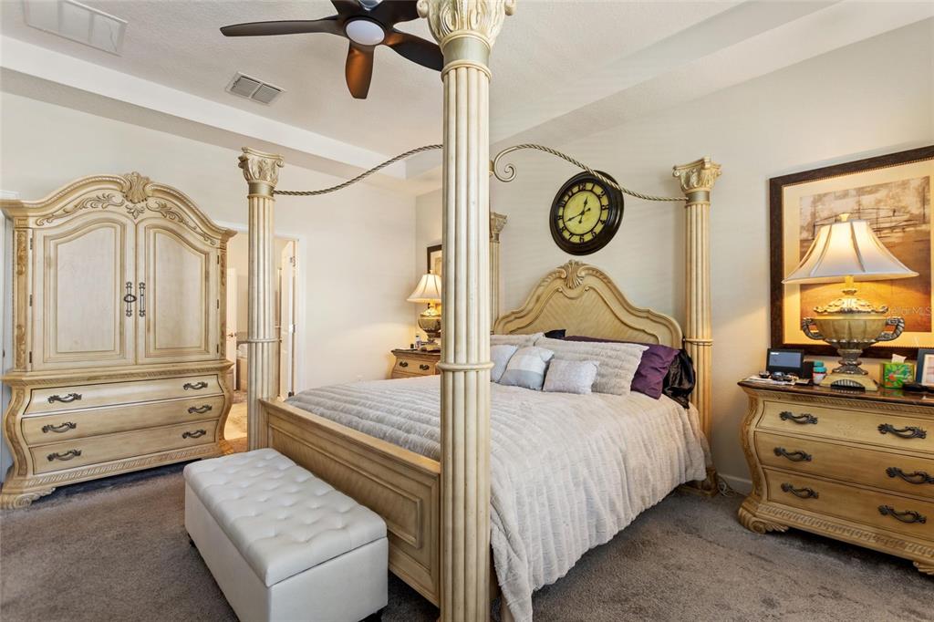 8811 Bally Neal Loop Davenport, FL 33896 - Photo 21 of 82 a bedroom with a bed and ceiling fan