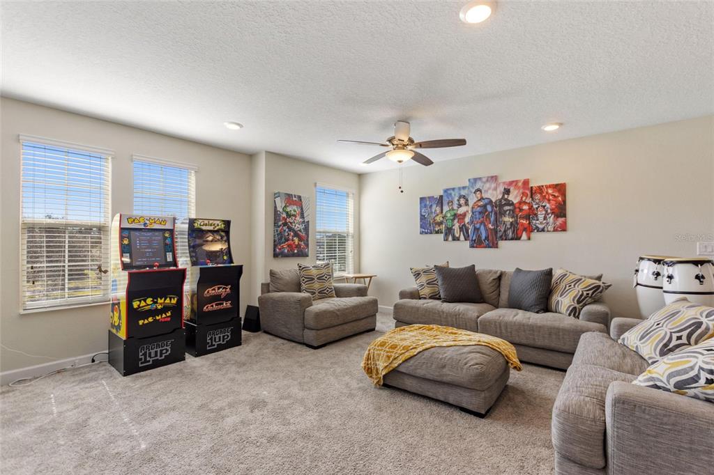 8811 Bally Neal Loop Davenport, FL 33896 - Photo 29 of 82 a living room with furniture and a flat screen tv