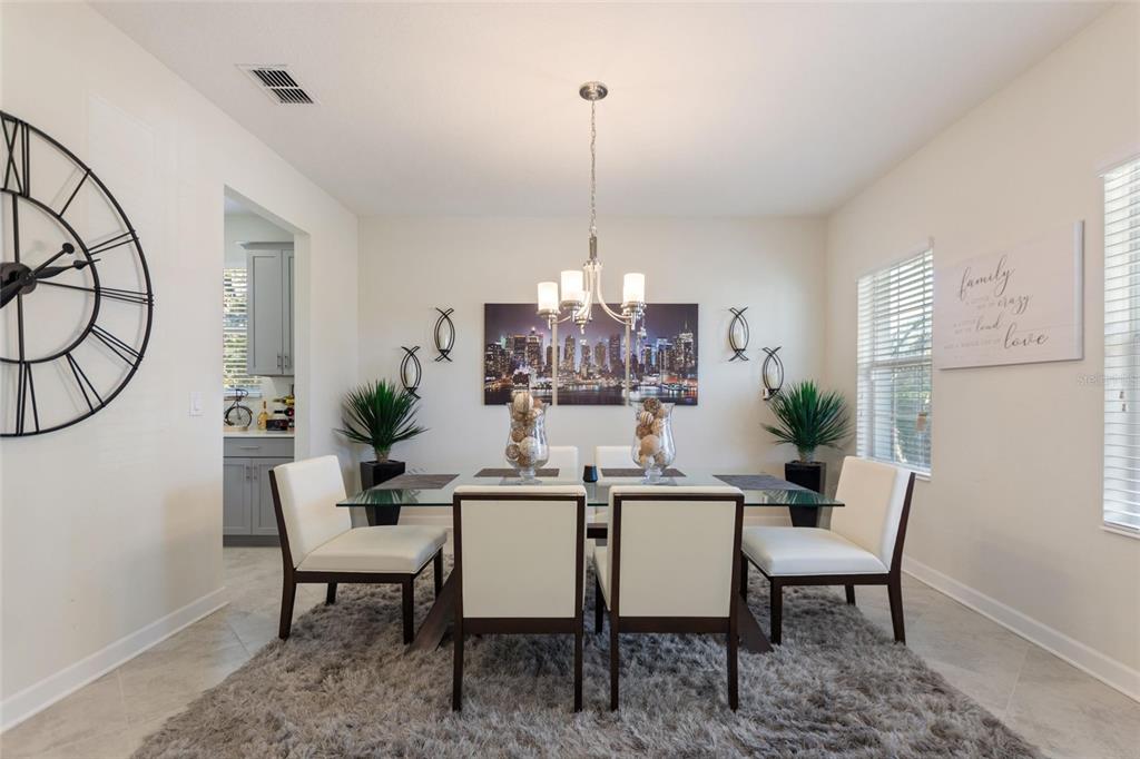 8811 Bally Neal Loop Davenport, FL 33896 - Photo 8 of 82 a dining room with furniture and window
