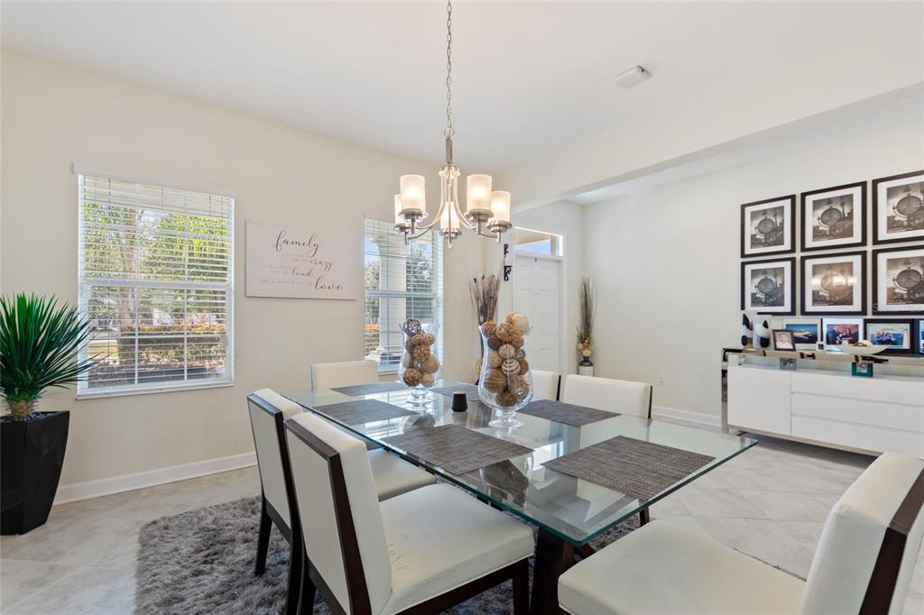 8811 Bally Neal Loop Davenport, FL 33896 - Photo 9 of 82 a view of a dining room with furniture window and wooden floor