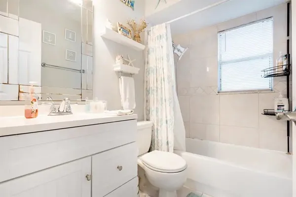 a bathroom with a sink toilet a mirror and shower