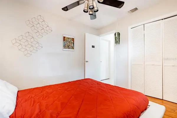 a large bedroom with a bed and a chandelier