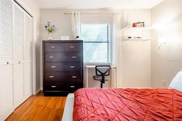 a bedroom with a bed and a dresser