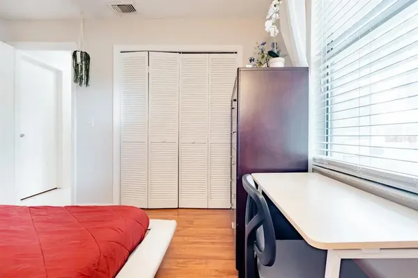 a bedroom with a bed and a window