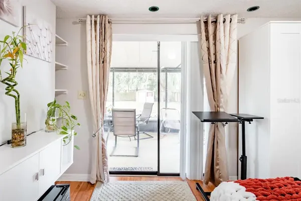 a view of walk in closet with window and wooden floor