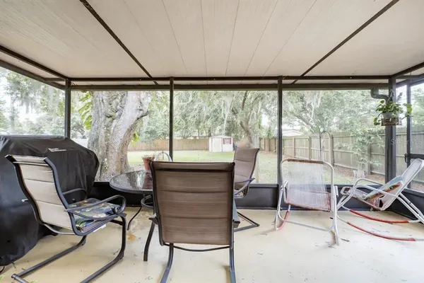 a work room with furniture and floor to ceiling windows