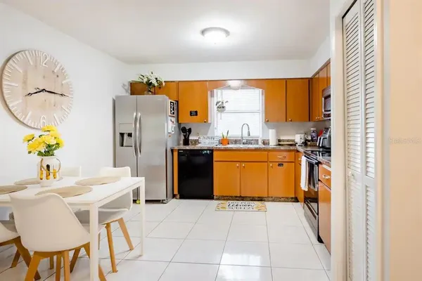 a kitchen with a sink appliances and cabinets