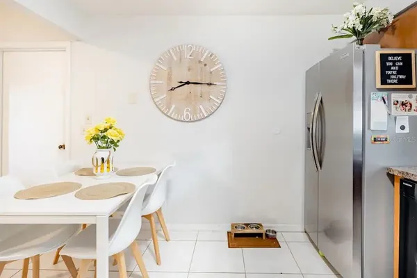 a dining room with furniture and a mirror