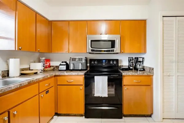 a kitchen with a sink a stove and a microwave