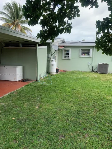 a house that has a tree in front of it