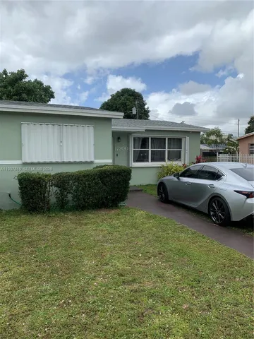 a view of a house with backyard space and a garden