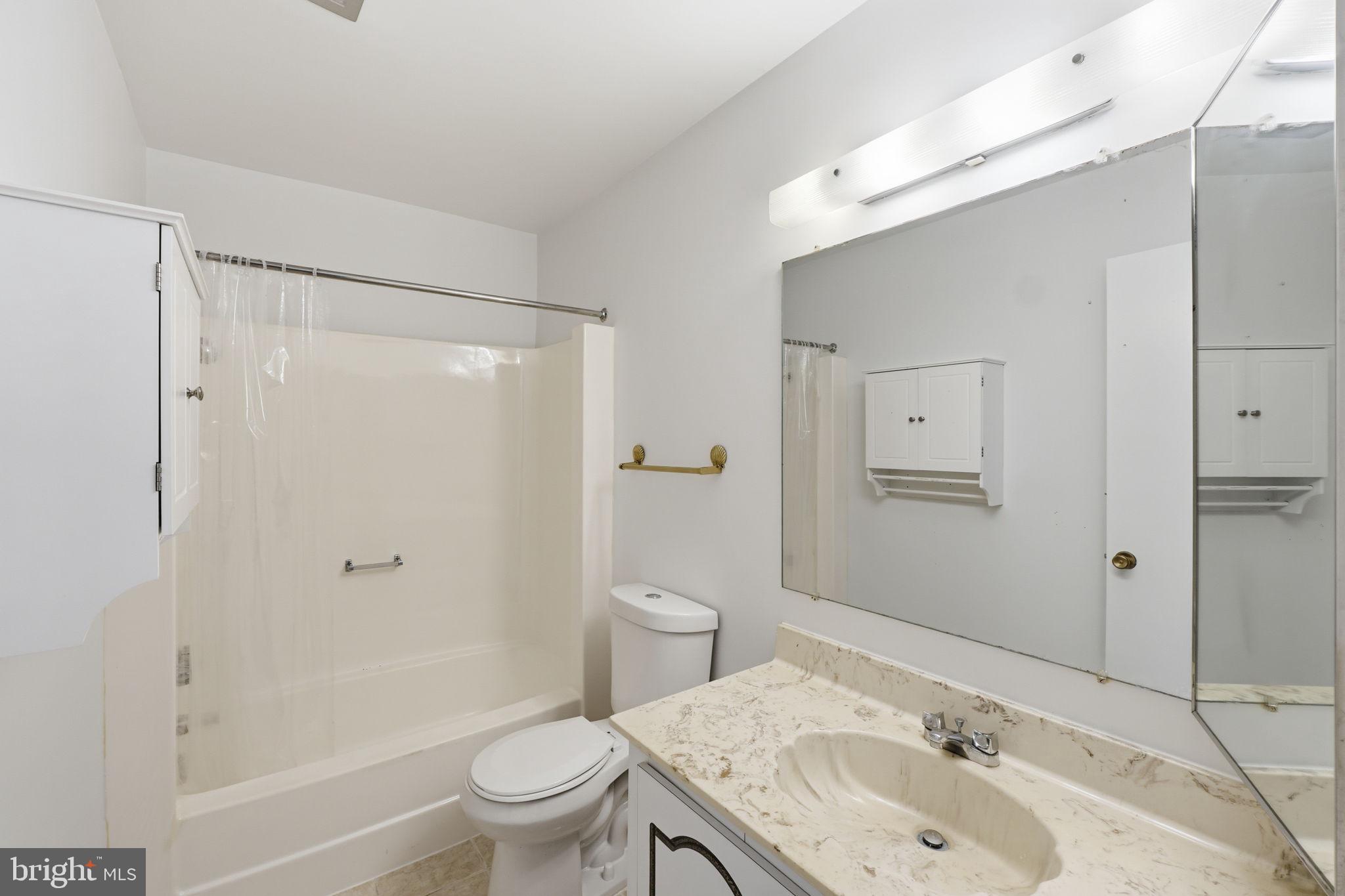 3103 Beckenham Court, Unit 252D Silver Spring, MD 20906 - Photo 27 of 32 a bathroom with a sink toilet and shower