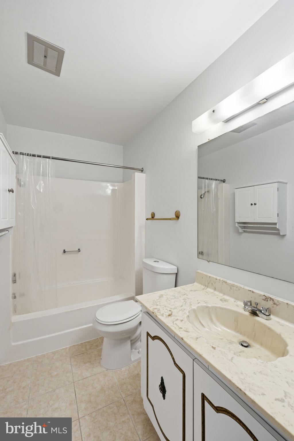 3103 Beckenham Court, Unit 252D Silver Spring, MD 20906 - Photo 28 of 32 a bathroom with a granite countertop sink a toilet and shower