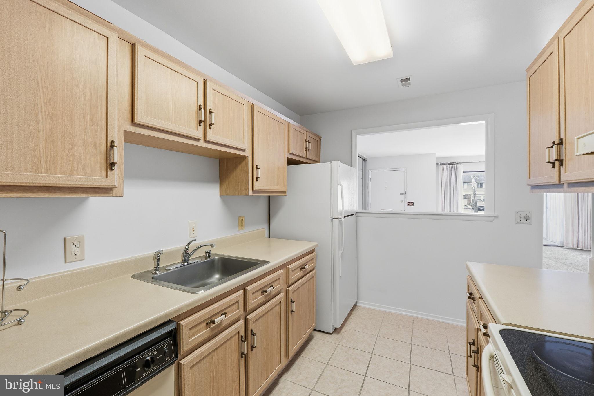 3103 Beckenham Court, Unit 252D Silver Spring, MD 20906 - Photo 9 of 32 a kitchen with stainless steel appliances a sink a stove a refrigerator and cabinets