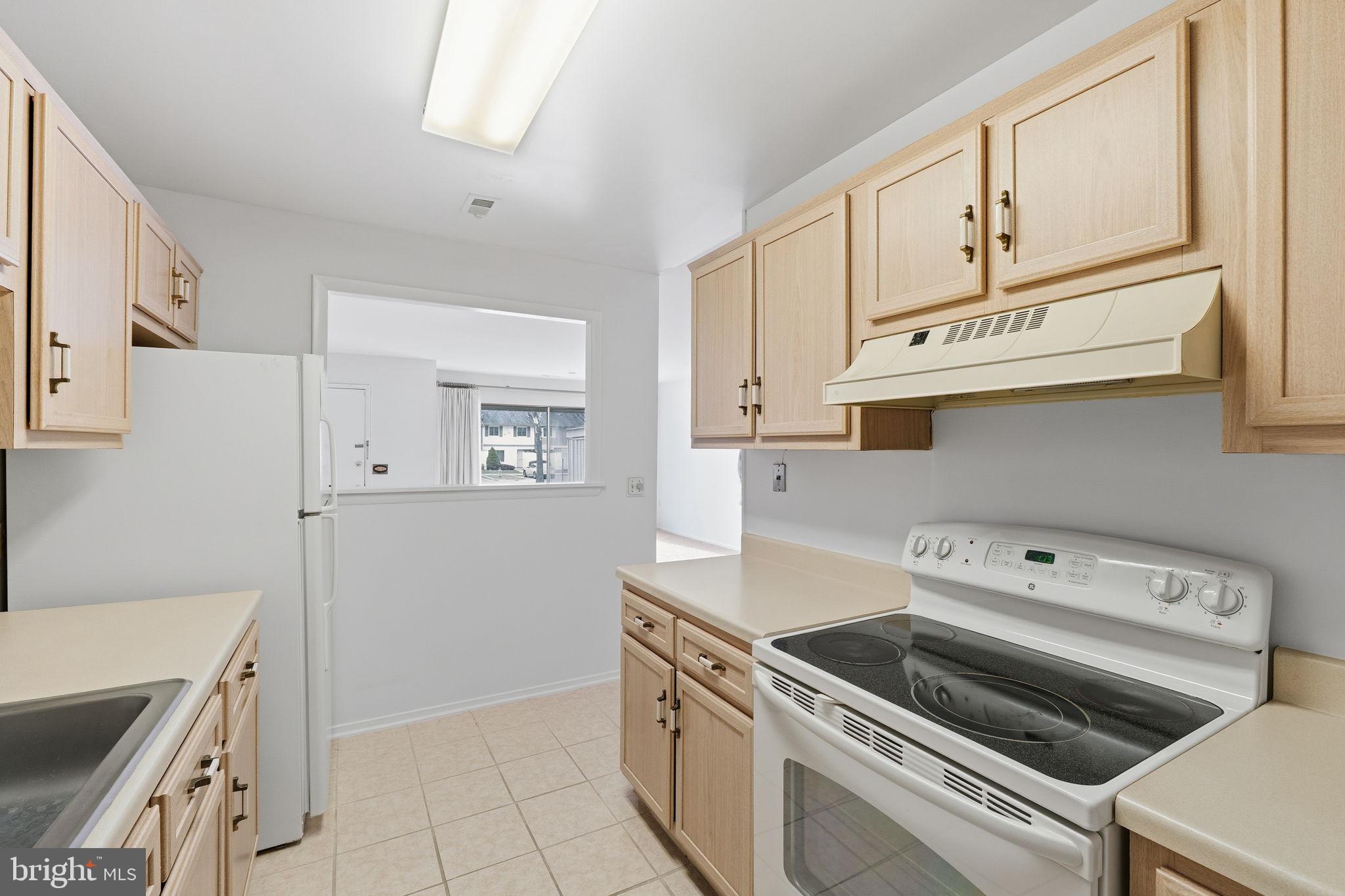 3103 Beckenham Court, Unit 252D Silver Spring, MD 20906 - Photo 10 of 32 a kitchen with cabinets stainless steel appliances and a counter space