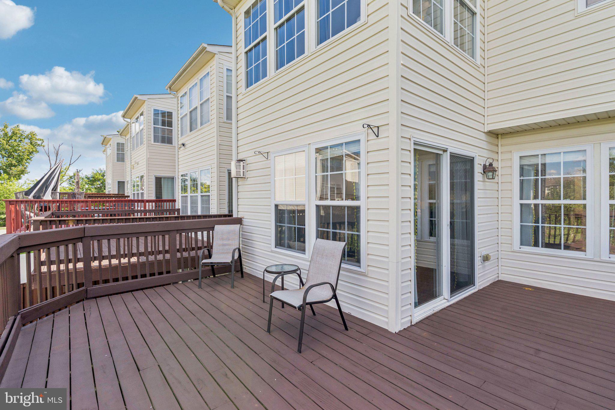 9740 Biggs Road Middle River, MD 21220 - Photo 14 of 37 a view of a deck with table and chairs with wooden floor and fence
