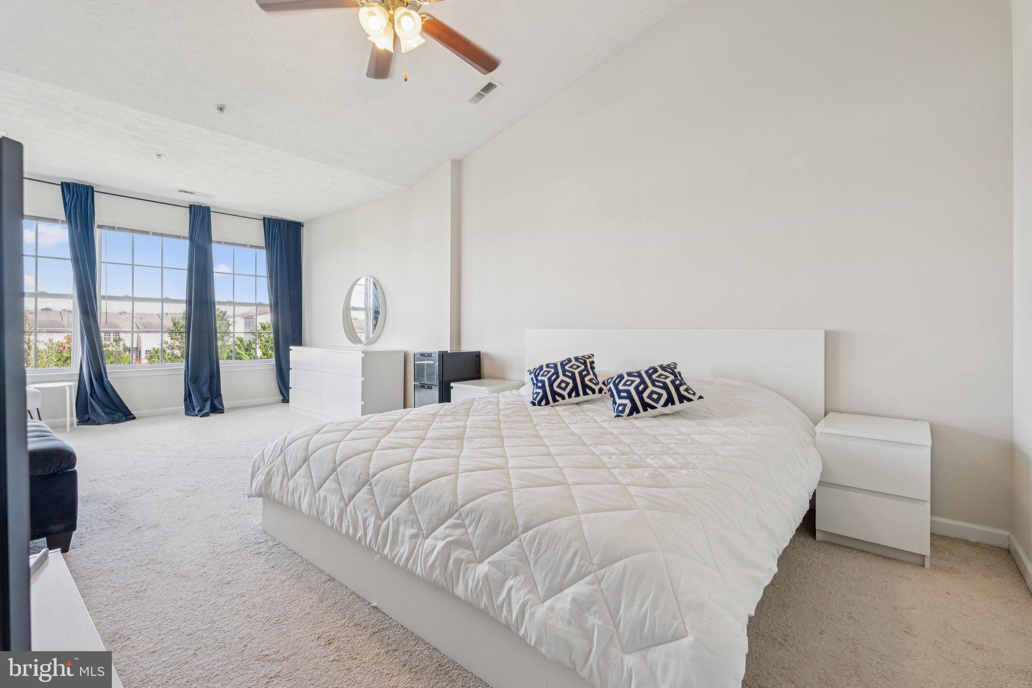 9740 Biggs Road Middle River, MD 21220 - Photo 16 of 37 a large bed sitting in a bedroom and a large window