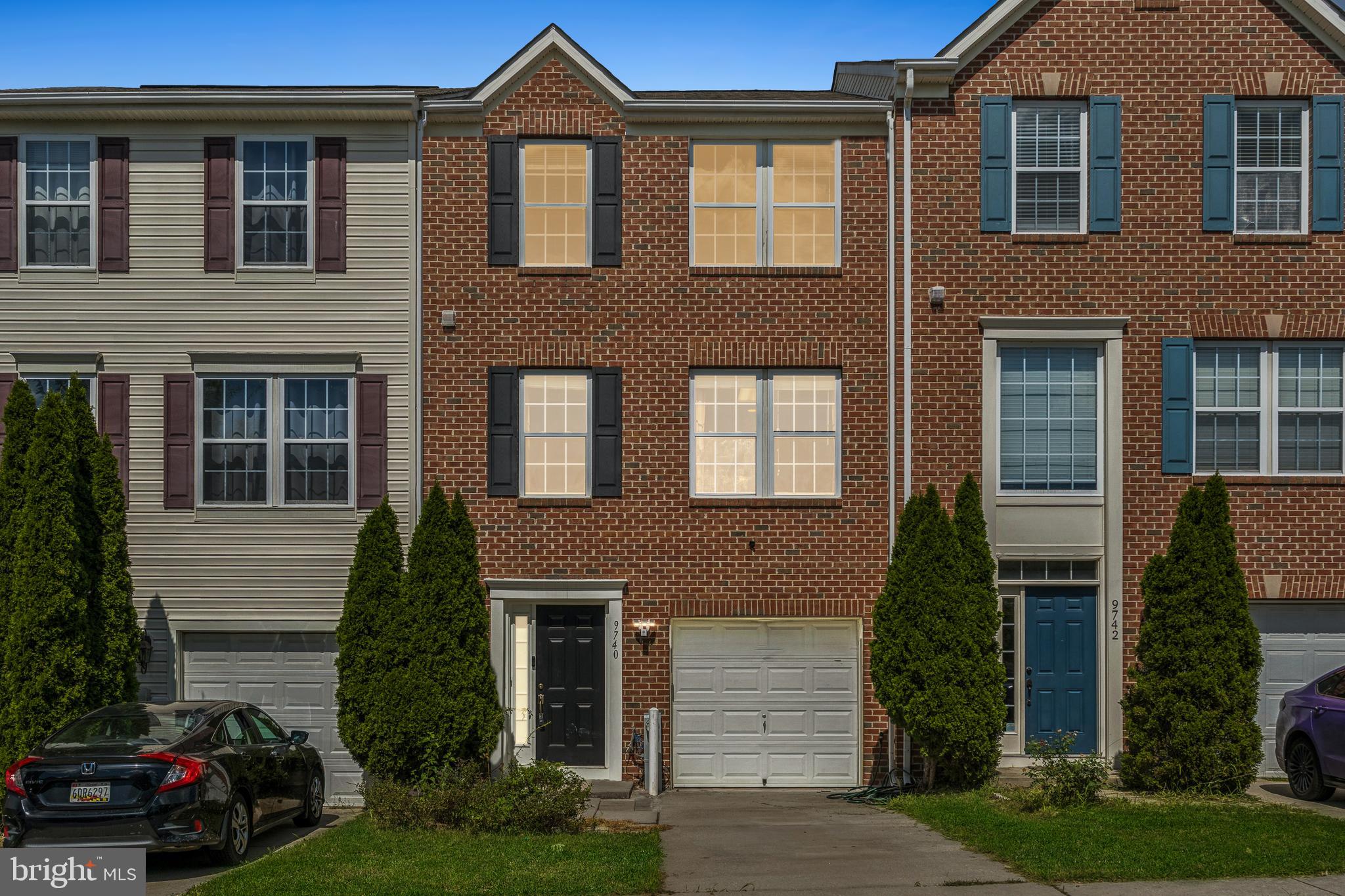 9740 Biggs Road Middle River, MD 21220 - Photo 2 of 37 a front view of a house with a yard and garage