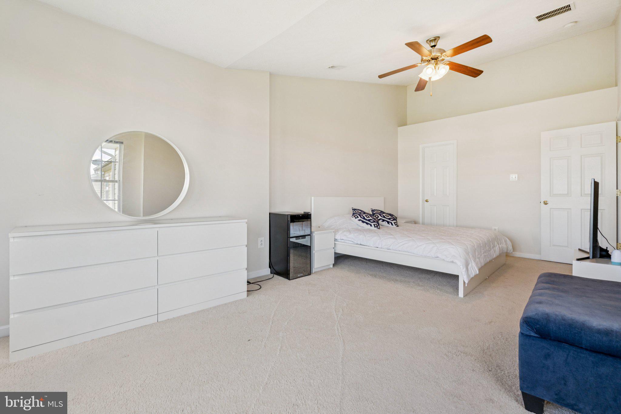 9740 Biggs Road Middle River, MD 21220 - Photo 21 of 37 a bedroom with a bed a mirror and lamp