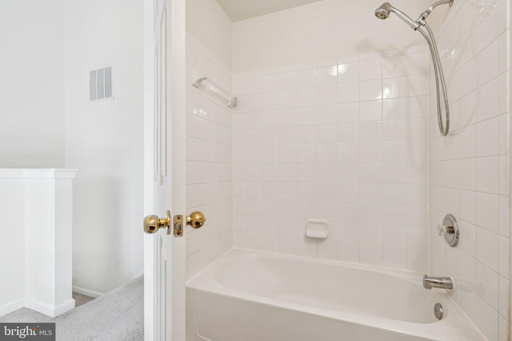 9740 Biggs Road Middle River, MD 21220 - Photo 30 of 37 a bathroom with a bathtub