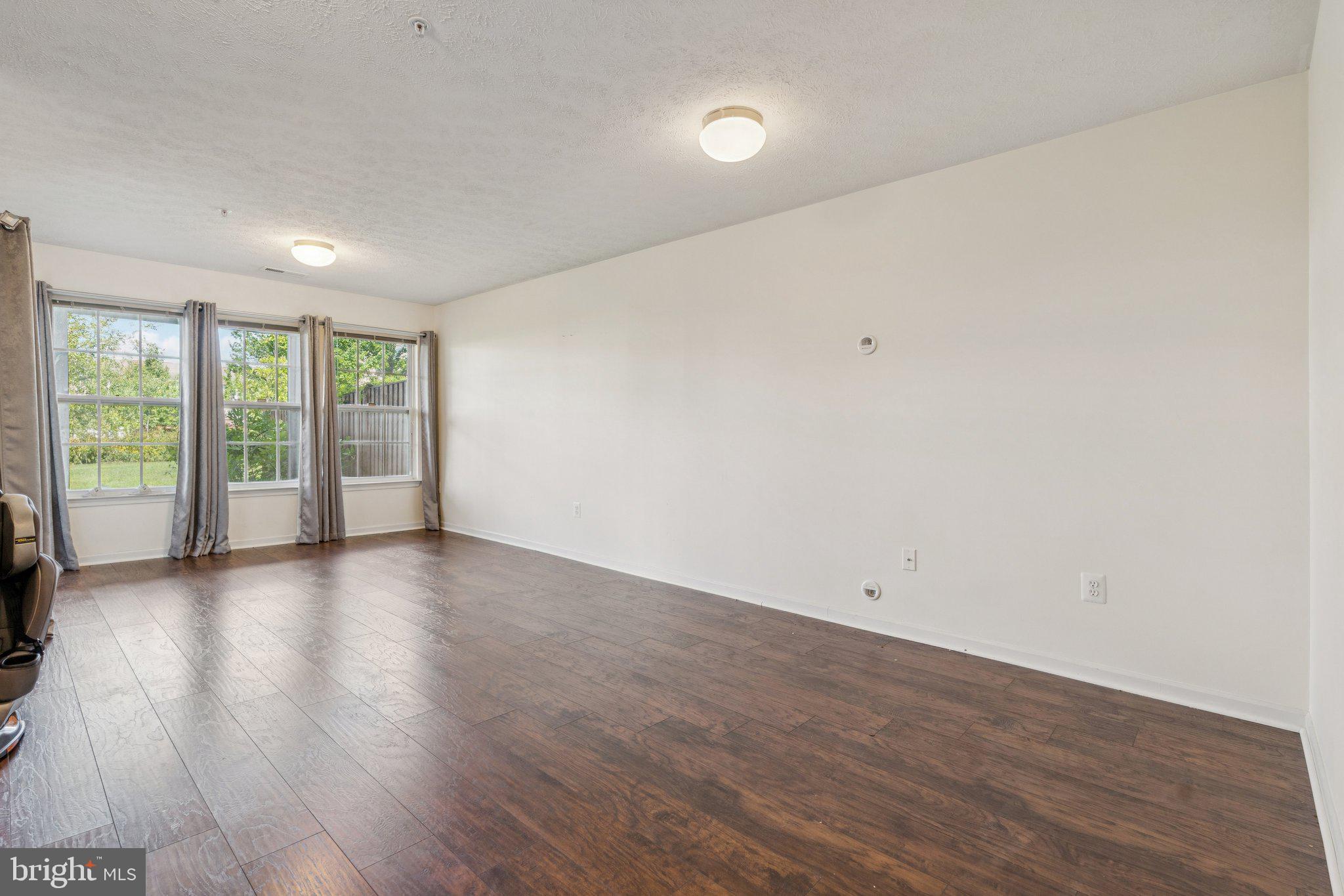 9740 Biggs Road Middle River, MD 21220 - Photo 31 of 37 wooden floor in an empty room with a window
