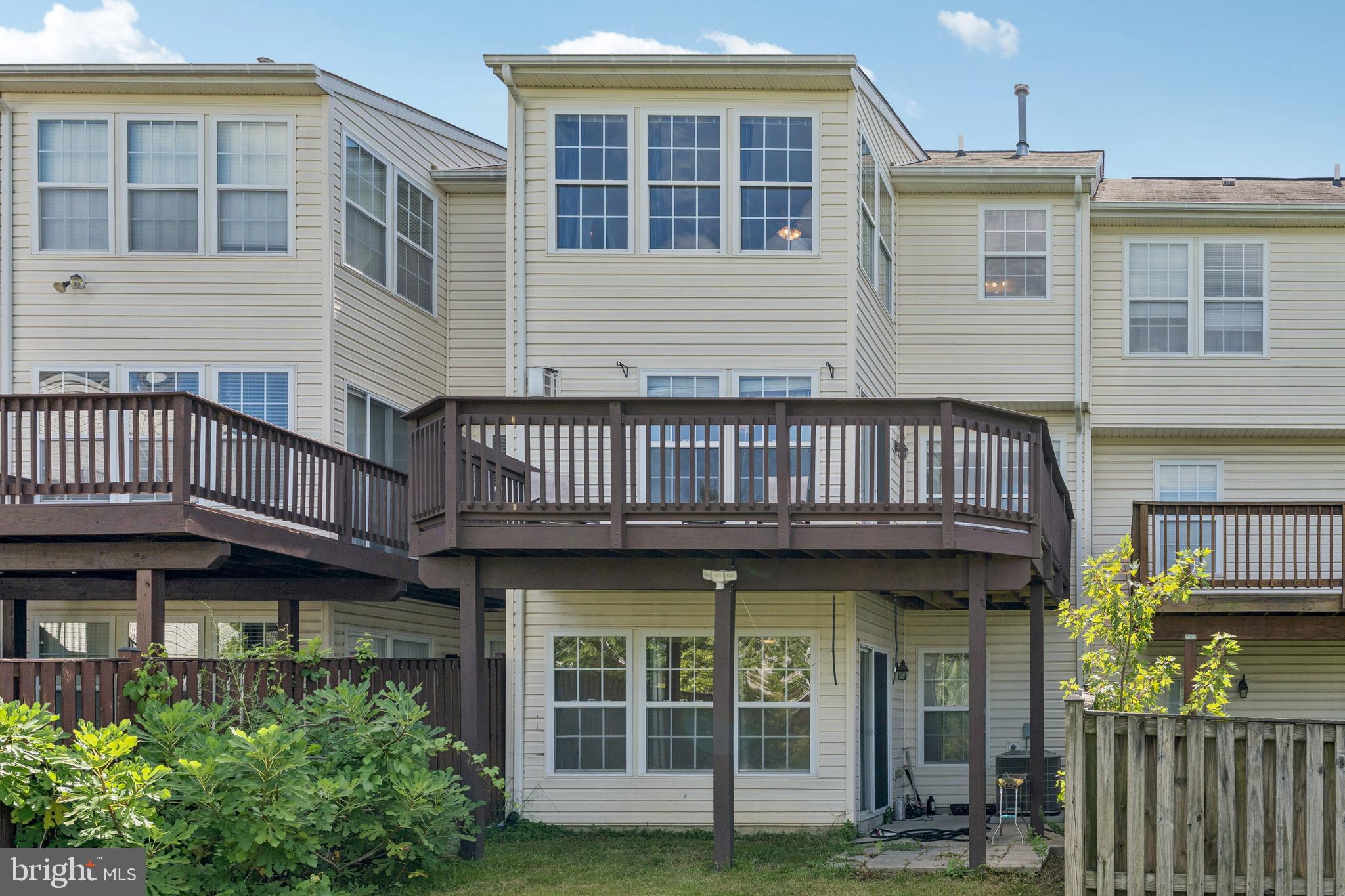 9740 Biggs Road Middle River, MD 21220 - Photo 34 of 37 a view of a brick house with large windows and a small yard