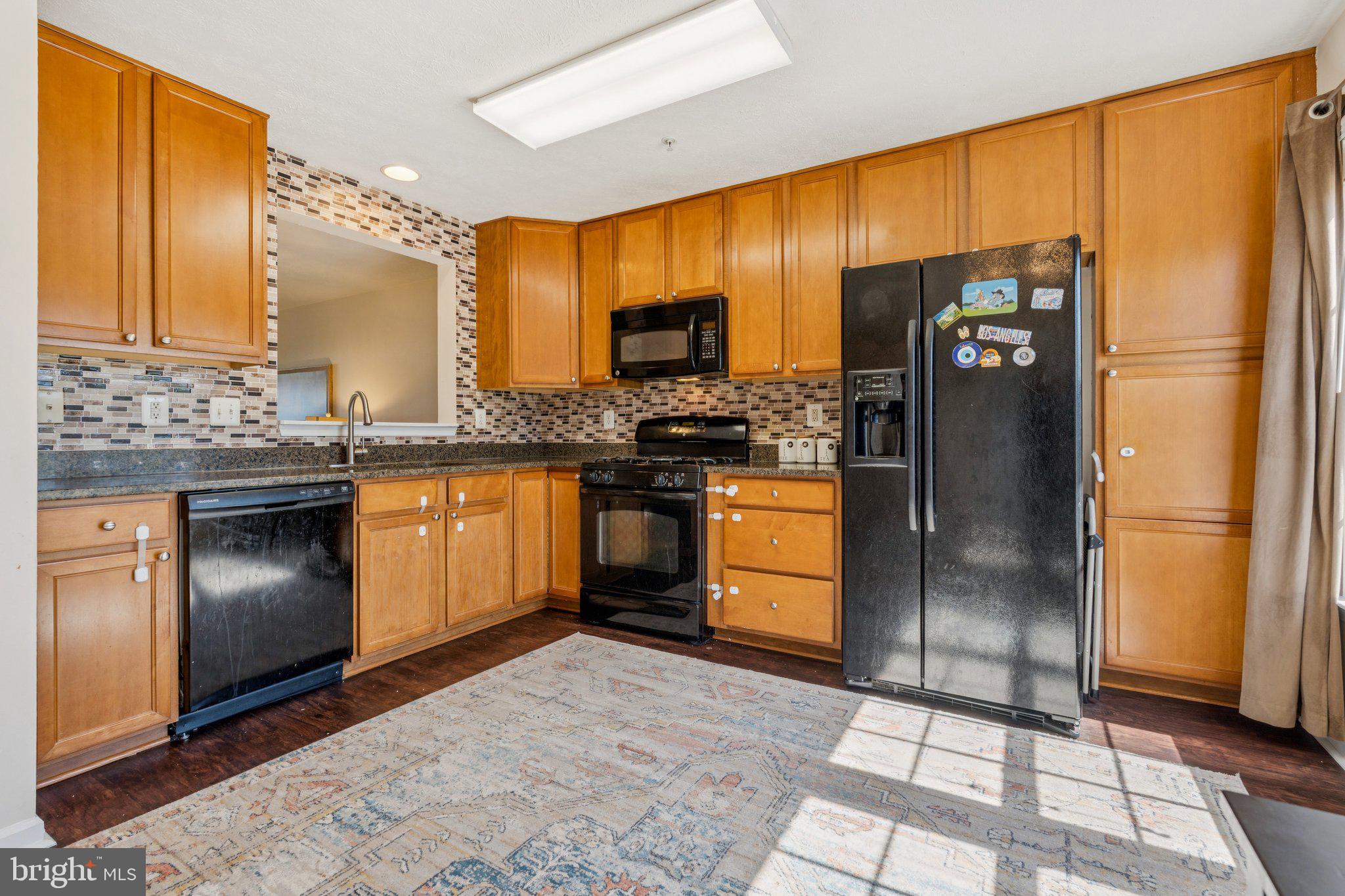 9740 Biggs Road Middle River, MD 21220 - Photo 10 of 37 a kitchen with stainless steel appliances granite countertop a refrigerator a stove a sink and dishwasher