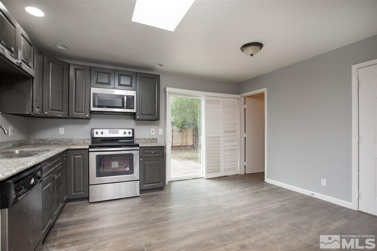 600 Akard Circle Reno, NV 89503 - Photo 11 of 25 a kitchen with kitchen island granite countertop a stove and a sink