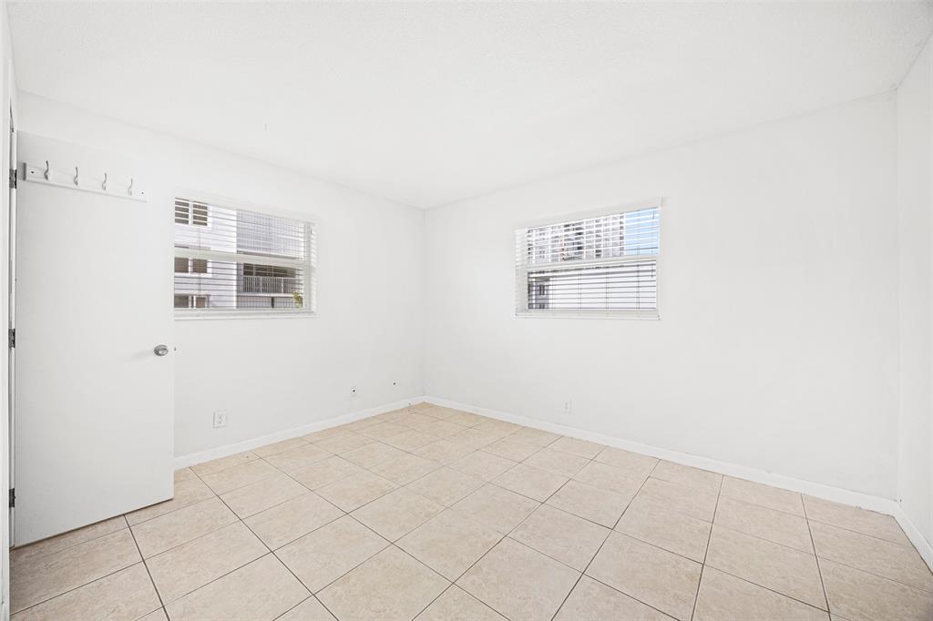 2131 North Ocean Boulevard, Unit 17 Fort Lauderdale, FL 33305 - Photo 12 of 27 an empty room with windows