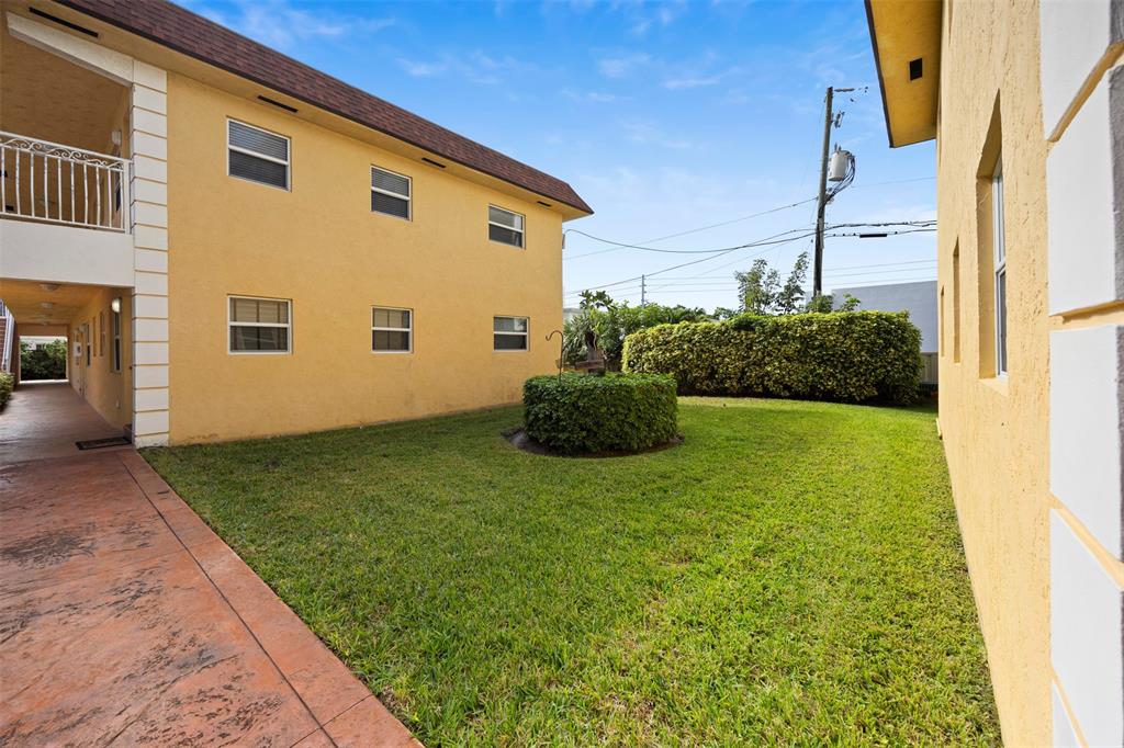 2131 North Ocean Boulevard, Unit 17 Fort Lauderdale, FL 33305 - Photo 24 of 27 a front view of a house with garden