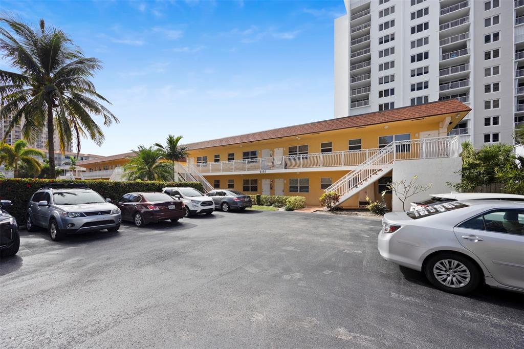 2131 North Ocean Boulevard, Unit 17 Fort Lauderdale, FL 33305 - Photo 25 of 27 a view of a car parked in front of a building