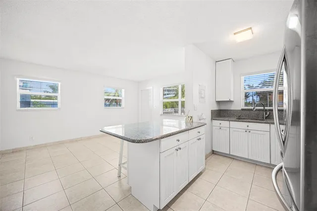 a kitchen with a sink cabinets and window