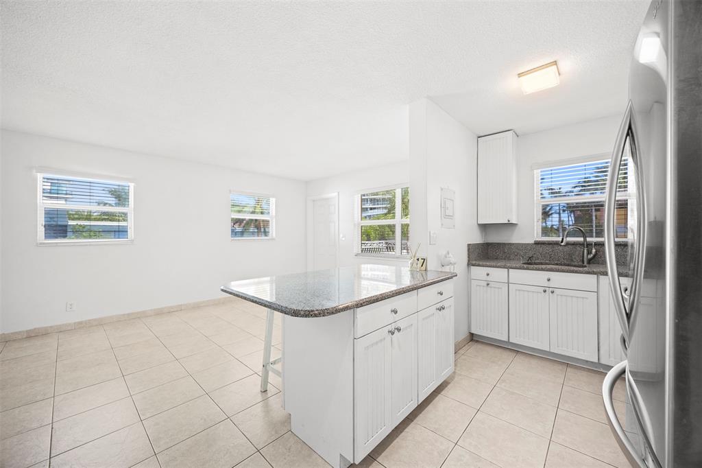 2131 North Ocean Boulevard, Unit 17 Fort Lauderdale, FL 33305 - Photo 5 of 27 a kitchen with a sink cabinets and window