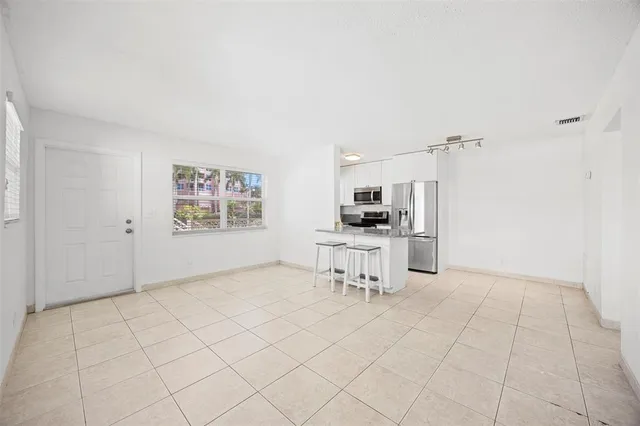 a view of kitchen with furniture and refrigerator