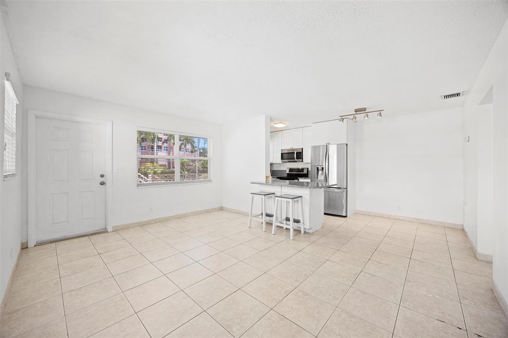2131 North Ocean Boulevard, Unit 17 Fort Lauderdale, FL 33305 - Photo 7 of 27 a view of kitchen with furniture and refrigerator