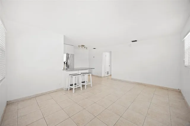 a view of a kitchen with table and chairs