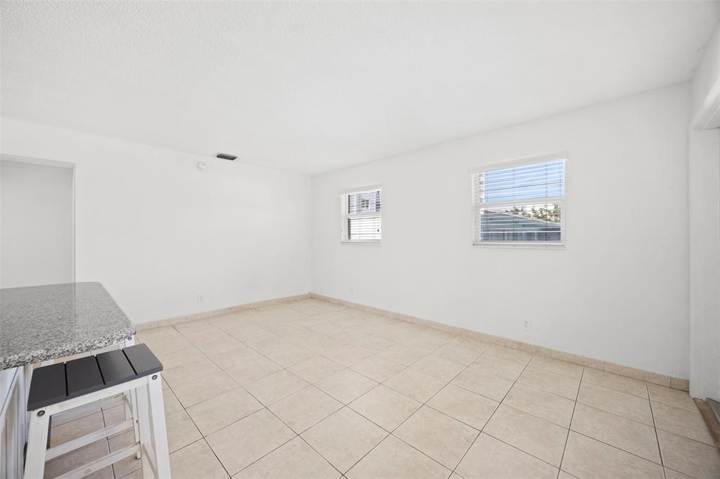 2131 North Ocean Boulevard, Unit 17 Fort Lauderdale, FL 33305 - Photo 9 of 27 an empty room with windows