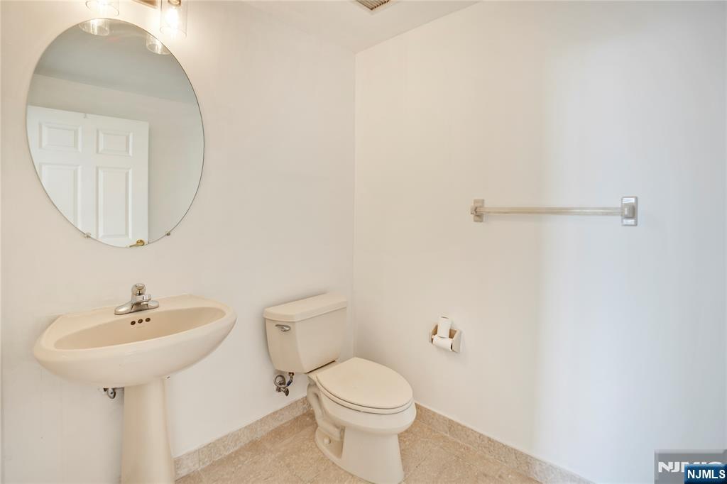 100 Old Palisade Road, Unit 2709 Fort Lee, NJ 07024 - Photo 13 of 15 a bathroom with a sink a mirror and toilet