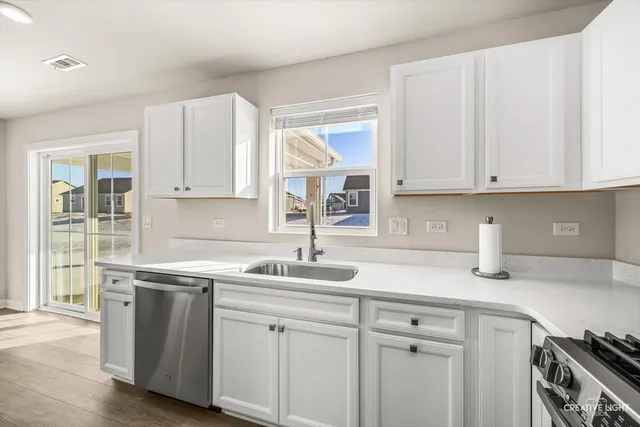 a kitchen with white cabinets and white appliances