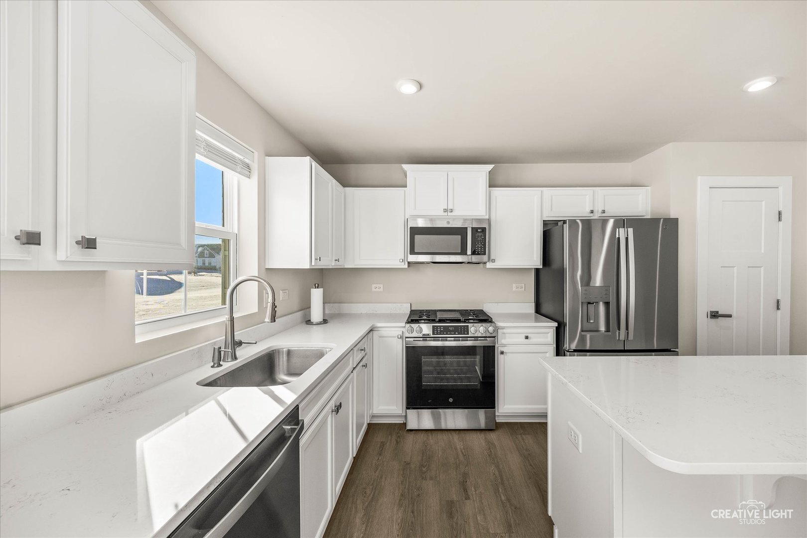 1237 Marigold Lane Hampshire, IL 60140 - Photo 13 of 27 a kitchen with a sink stove top oven and refrigerator