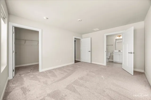 an empty room with closet and a bathroom