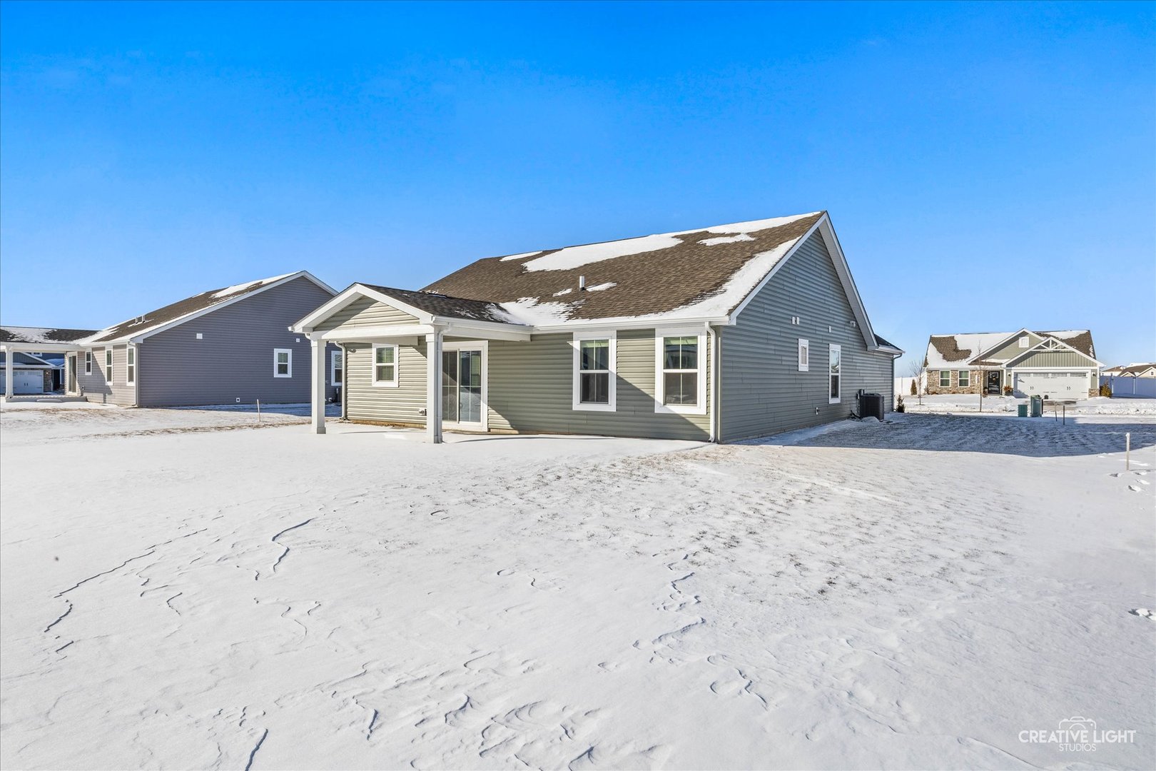 1237 Marigold Lane Hampshire, IL 60140 - Photo 23 of 27 a front view of a house with a dirt yard and a large window