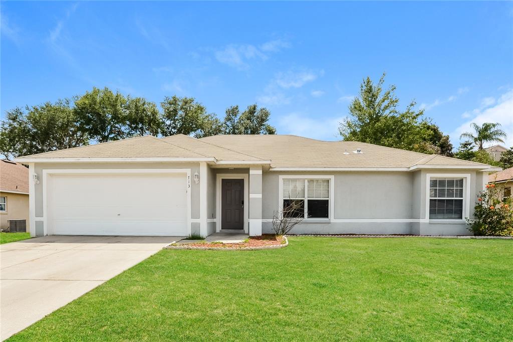 713 Willow Run Street Minneola, FL 34715 - Photo 1 of 16 a view of a house with backyard and garden